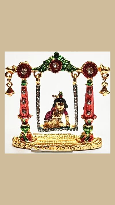 Little Krishna on a swing, a gilded murti