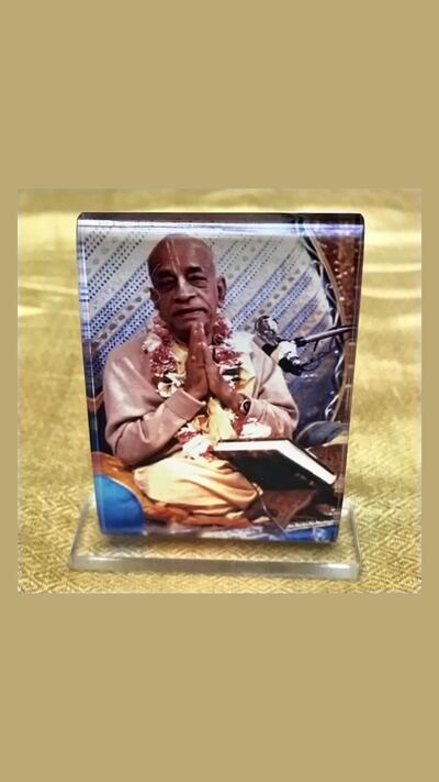 A picture of Prabhupada, 7 x 5 cm, on a blue background
