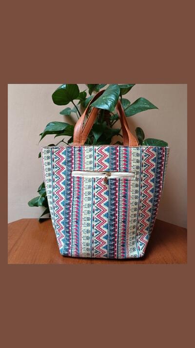 Textile handbag with leather trim