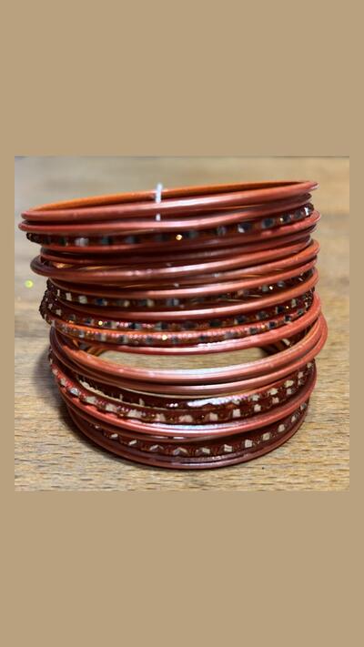Set of 24 orange and silver bracelets with a faceted finish