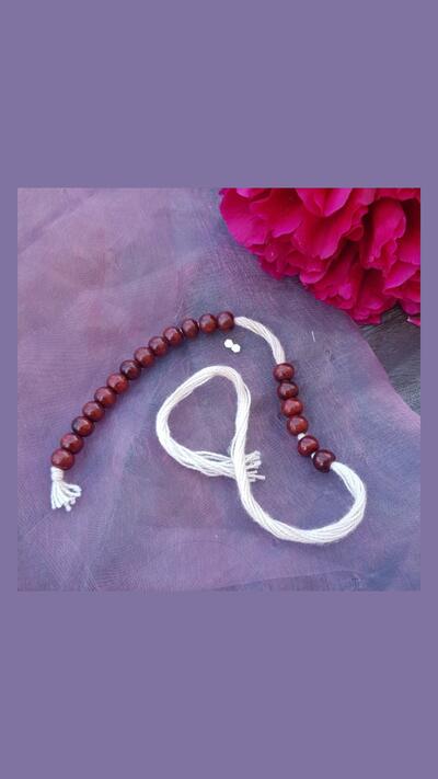 Japa bead counter in a brown sandalwood bag. Beads without a tassel