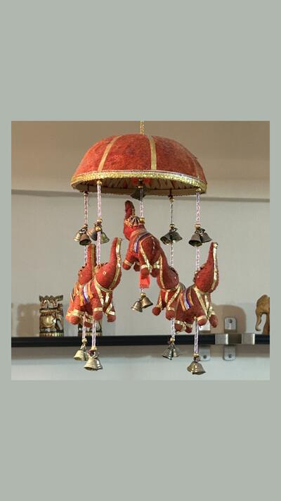 Hanging elephants under a parasol