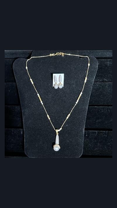 Vrinda Creation Necklace with a pearl and earrings